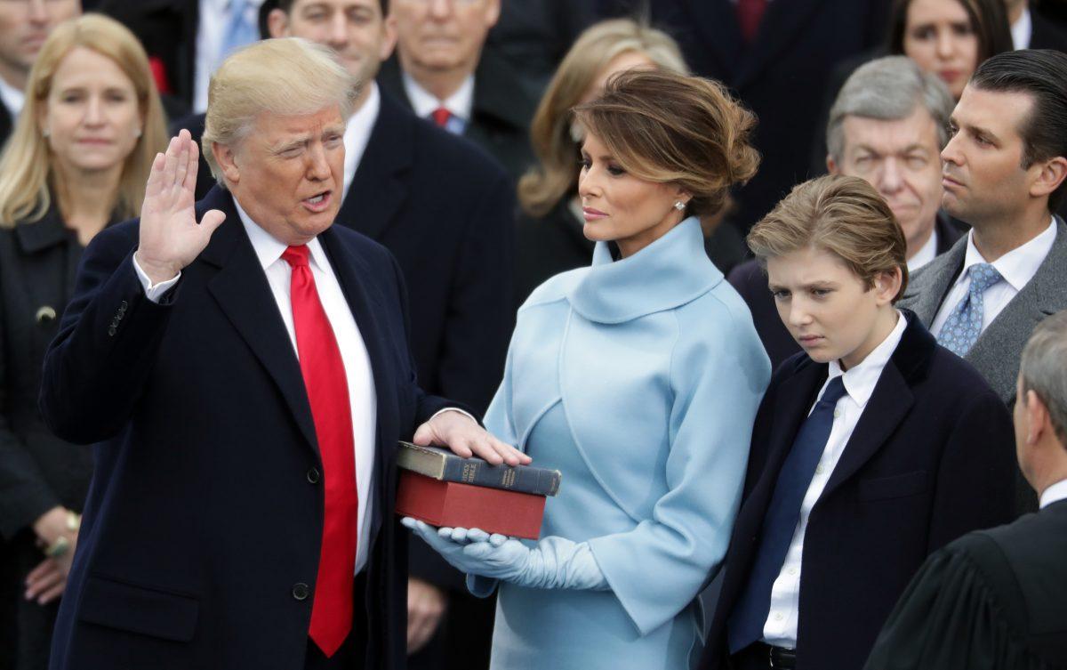 U.S. President Donald Trump takes the oath of office as his wife Melania Trump holds the bible and his son Barron Trump looks on, on the West Front of the U.S. Capitol in Washington on Jan. 20, 2017. (Chip Somodevilla/Getty Images)