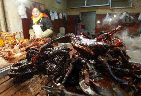 Cooked ducks and chickens on sale at a market stall in Beijing in January 2004. (Frederuc J. Brown/AFP/Getty Images)