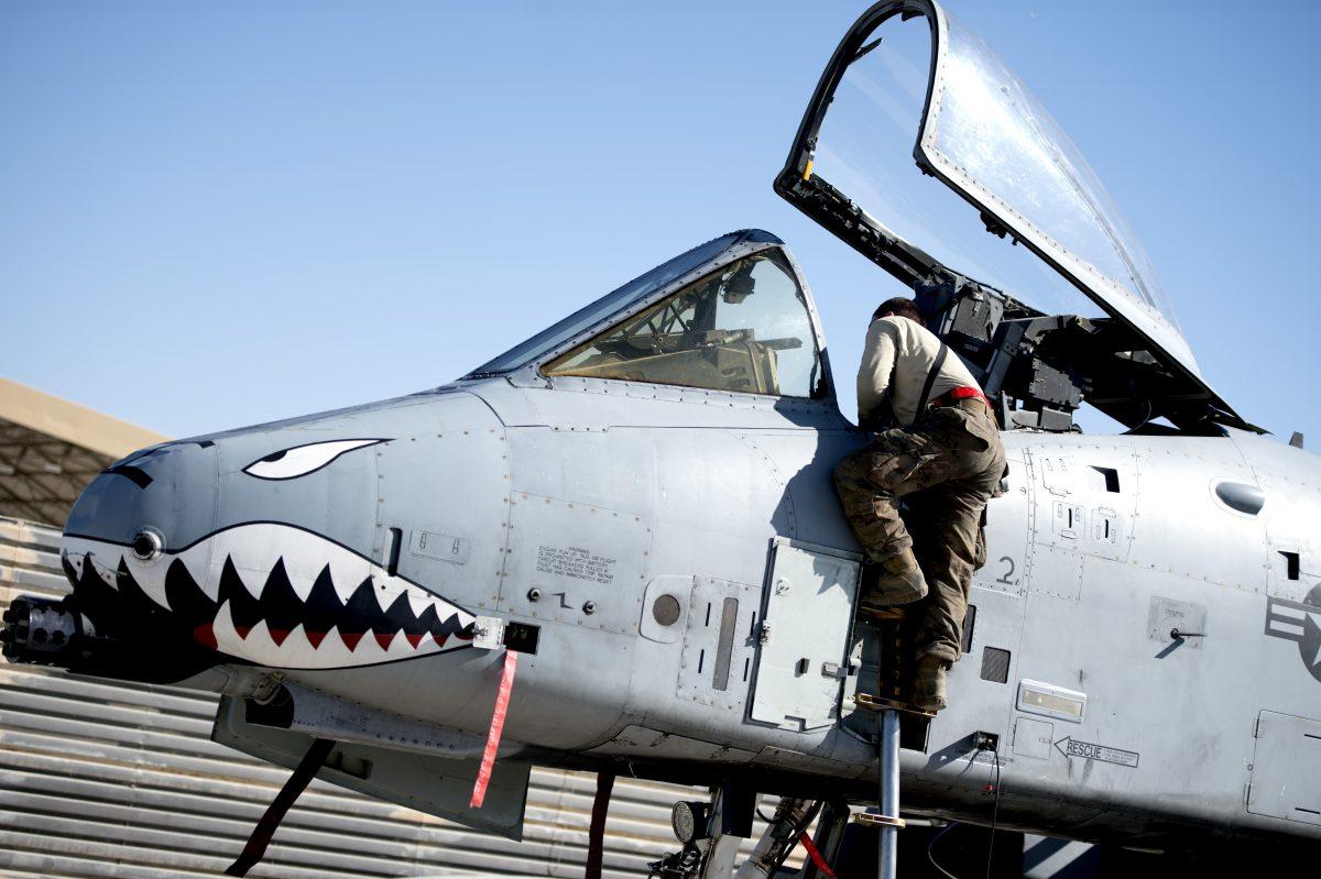 A mechanic works on a U.S. Airforce A-10 "Warthog" close support bomber at Al Udeid Airbase in Qatar. (U.S. Air Forces Central Command)