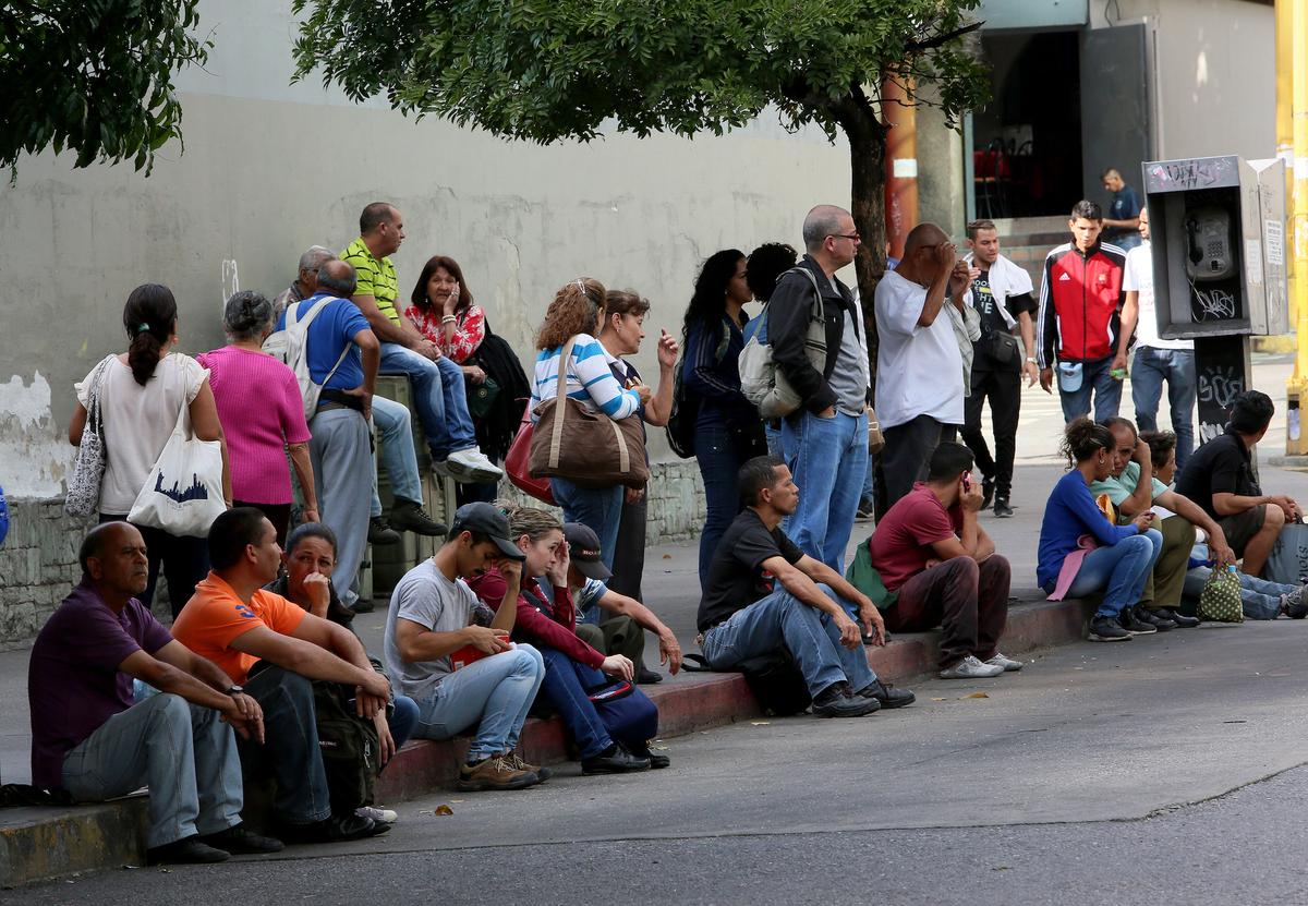 People make long queues to take the bus due to a collapse in the public transport system on Jan. 31, 2019 in Caracas, Venezuela. (Edilzon Gamez/Getty Images)