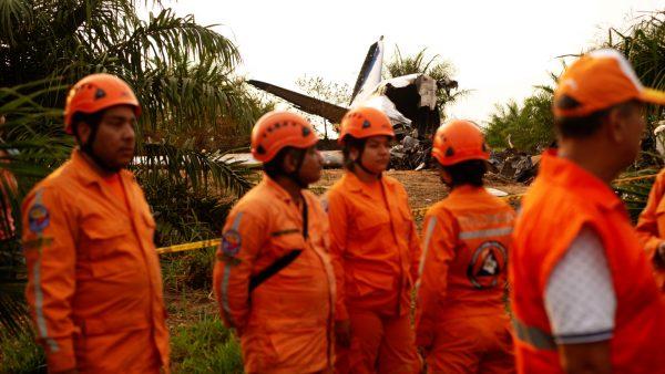 Members of the Colombian civil defense work where a plane crashed in the Colombian plains province of Meta, San Martin, Colombia on March 9, 2019. (Santiago Molina/Reuters)