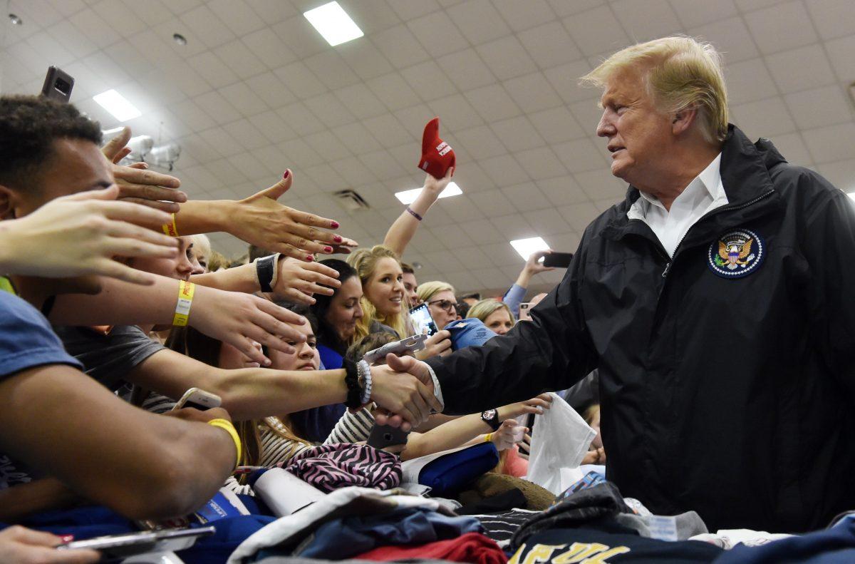 President Donald Trump greets residents in Opelika, Alabama, during a tour of tornado-damaged areas in the southern U.S. state on March 8, 2019. (Nicholas Kamm/AFP/Getty Images)
