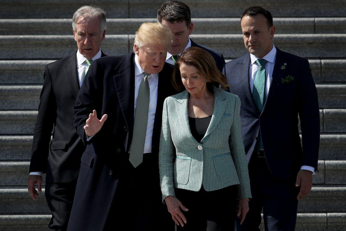 President Donald Trump confers with Speaker of the House Nancy Pelosi (D-CA) while departing the Capitol following a St. Patrick's Day celebration in Washington, on March 14, 2019. (Win McNamee/Getty Images)