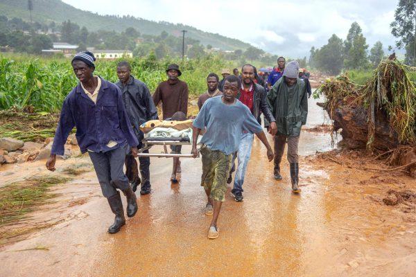 A rescued man is seen carried on a stretcher bed in Ngangu township, Chimanimani, eastern Zimbabwe, on March 18, 2019, after the area was hit by the cyclone Idai. (Zinyange Auntony/AFP/Getty Images)