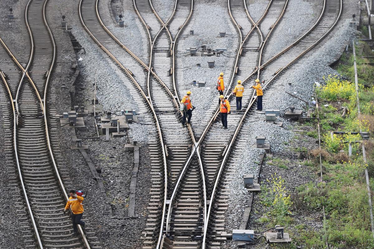 Workers inspect railway tracks, which serve as a part of the Belt and Road Initiative freight rail route linking Chongqing to Duisburg, at the Dazhou railway station in Sichuan Province, China, on March 14, 2019. (Reuters)