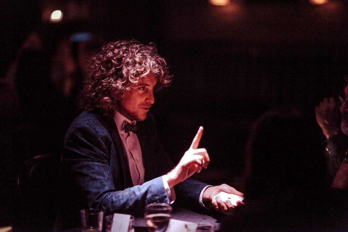 Matias Letelier performing at an individual table of guests. (giafrese for The McKittrick Hotel)