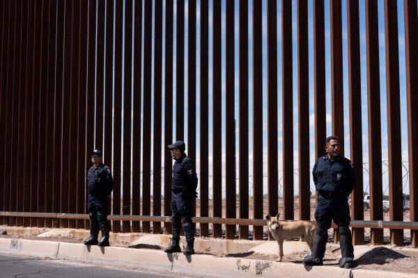 Mexico's federal police stand guard at the US-Mexico border fence as President Donald Trump visits Calexico, California (Guillermo Arias/AFP/Getty Images)