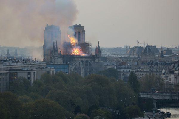 Flames and smoke are seen billowing from the roof at Notre-Dame Cathedral in Paris on April 15, 2019. As images such as this emerge, some people claim they can see religious figures in the flames. (Ludovic Marin/AFP/Getty Images)