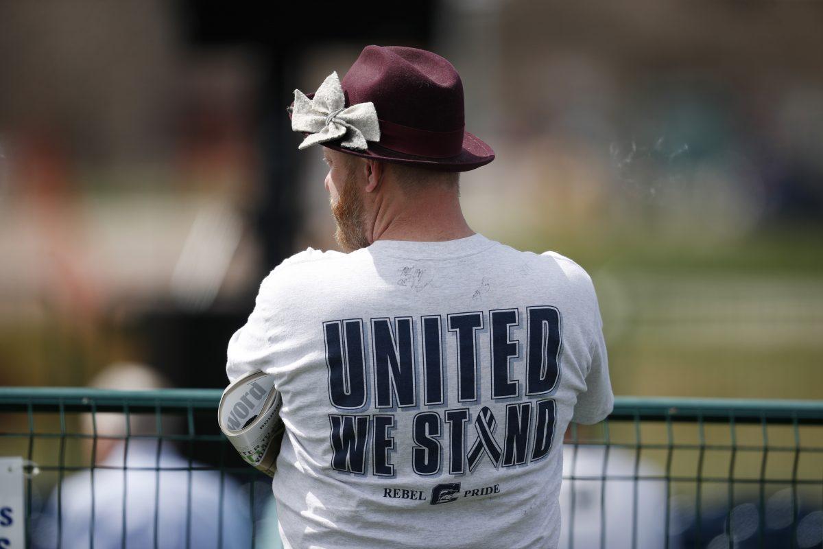 A participant looks on wearing a shirt bearing a message of support for Columbine High School during a program for the victims of the massacre at the school 20 years ago, in Littleton, Colo., on April 20, 2019. (David Zalubowski/AP Photo)