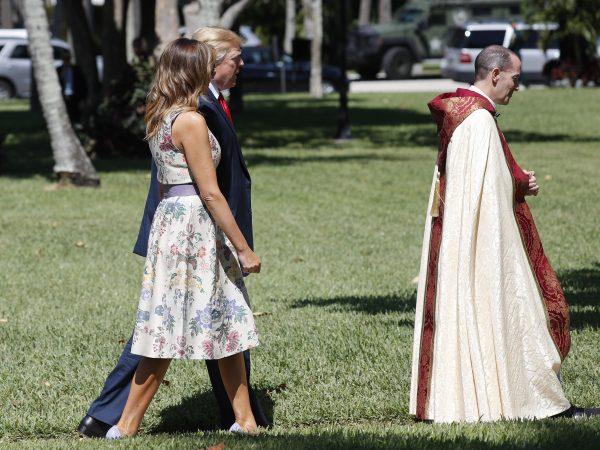 President Donald Trump with first lady Melania Trump, walk behind the Rev. James R. Harlan, right, as they arrive for Easter services at Episcopal Church of Bethesda-by-the-Sea in Palm Beach, Fla., on April 21, 2019. (Pablo Martinez Monsivais/AP Photo)