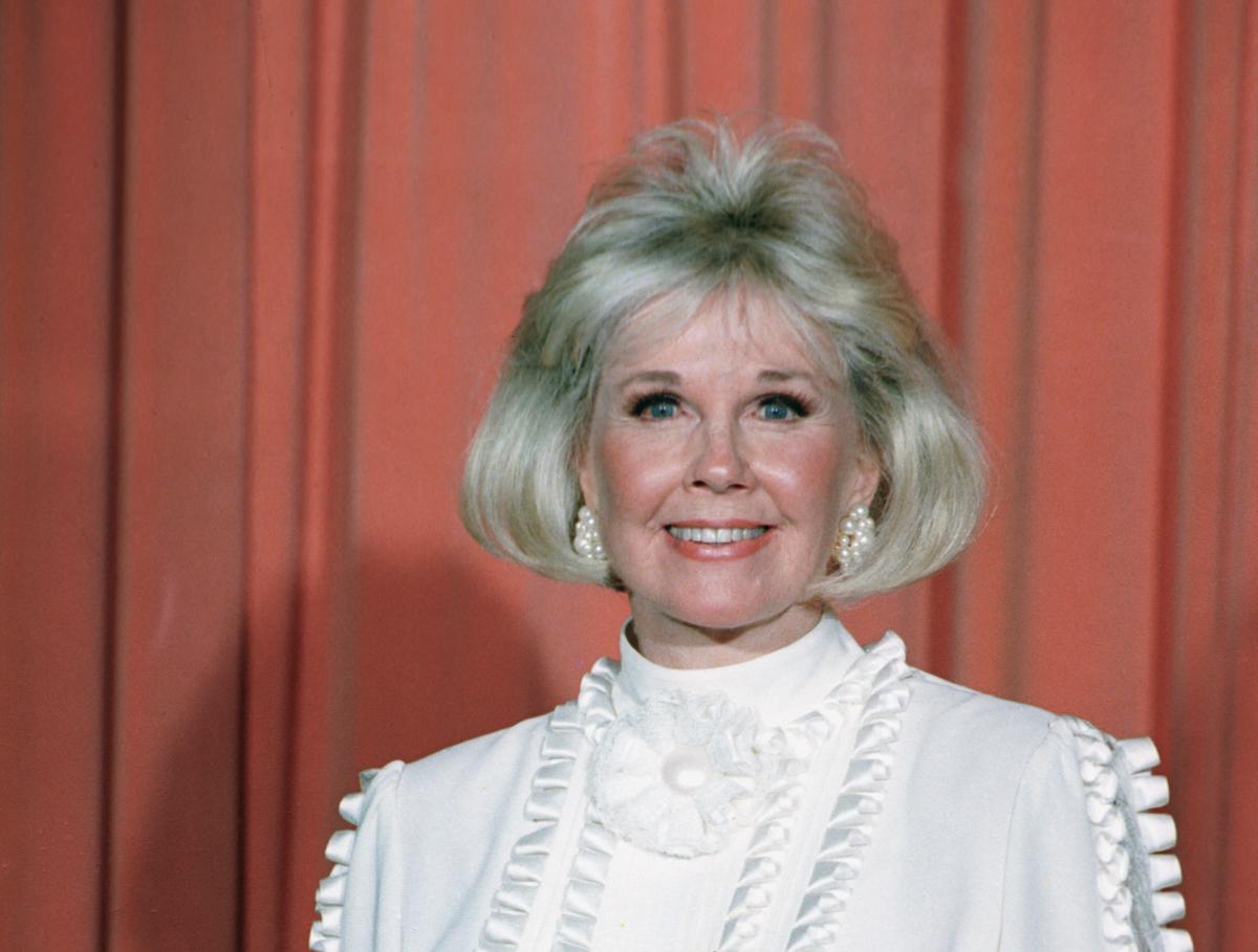 Actress and animal rights activist Doris Day poses for photos after receiving the Cecil B. DeMille Award she was presented with at the annual Golden Globe Awards ceremony in Los Angeles on Jan. 28, 1989. (AP Photo)