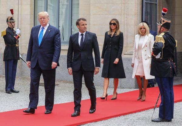 (L/R): US President Donald Trump, French President Emmanuel Macron, US First Lady Melania Trump and French President's wife Brigitte Macron walk past members of the Republican Guard prior to meeting and a lunch at the Prefecture of Caen, Normandy, north-western France, on June 6, 2019, as part of D-Day commemorations marking the 75th anniversary of the World War II Allied landings in Normandy. (Ludovic Marin/AFP/Getty Images)