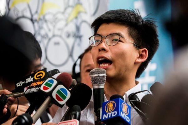 Hong Kong democracy activist Joshua Wong (centre R) speaks to the media after leaving Lai Chi Kok Correctional Institute in Hong Kong on June 17, 2019. (ISAAC LAWRENCE/AFP/Getty Images)