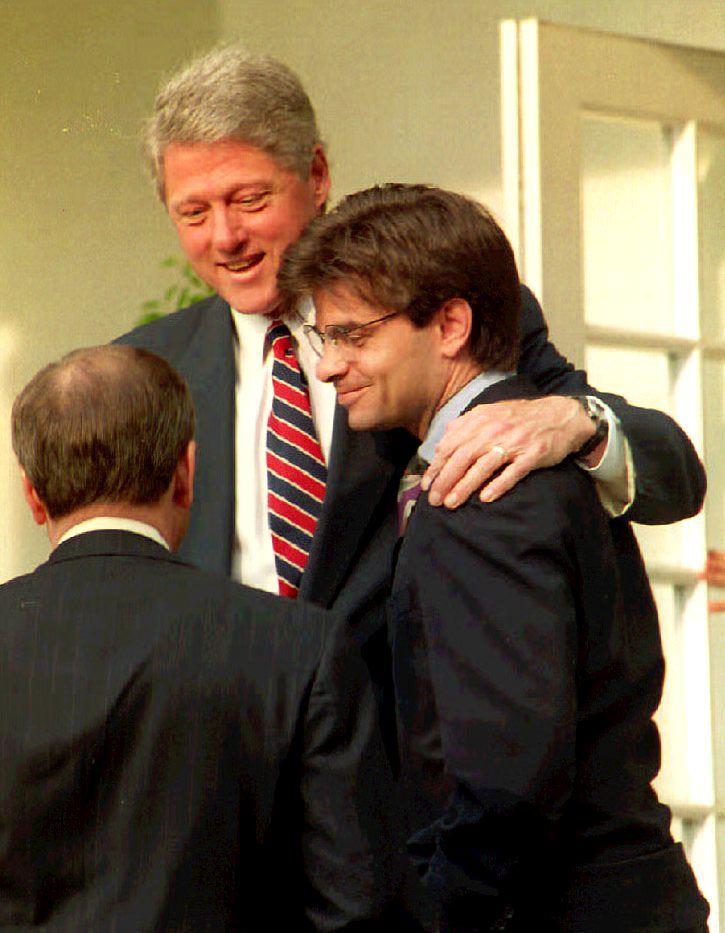 President Bill Clinton (C) speaks to White House Chief of Staff Thomas McLarty (L) with his arm around George Stephanopoulos (R) in the Rose Garden of the White House on May 29, 1993. (Jennifer Law/AFP/Getty Images)