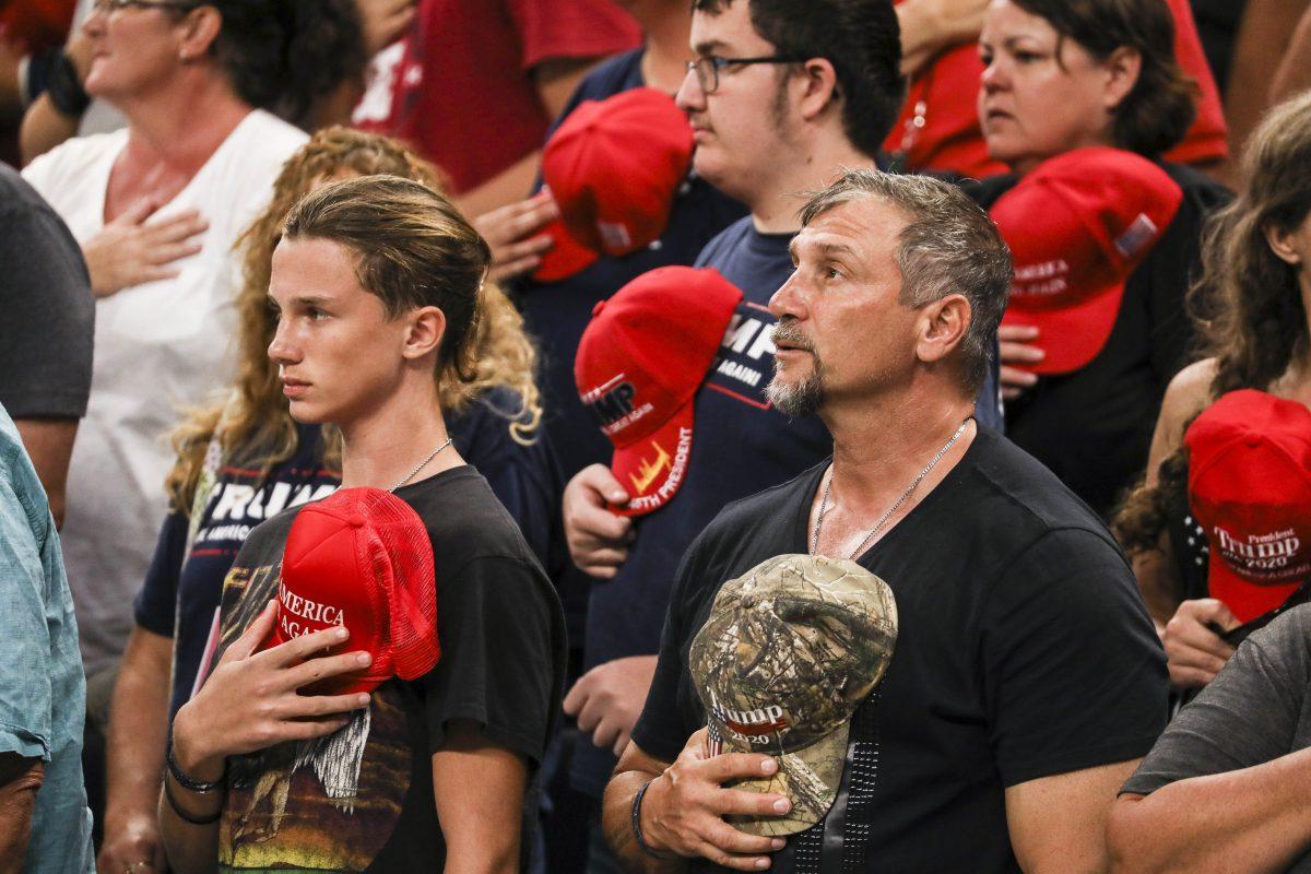 Audience members during the national anthem at President Donald Trump’s 2020 re-election event in Orlando, Fla., on June 18, 2019. (Charlotte Cuthbertson/The Epoch Times)