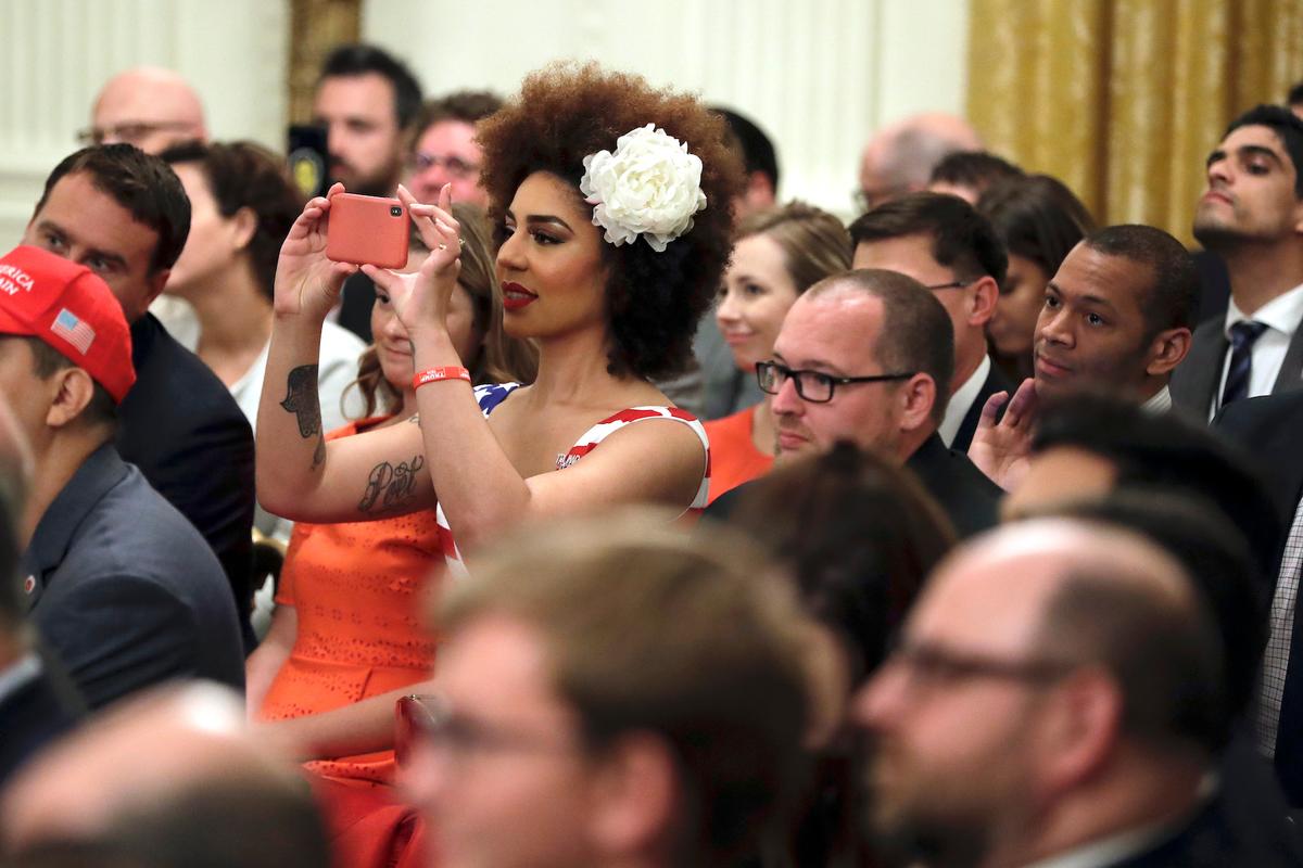 Invited guests take photos as President Donald Trump speaks during the Presidential Social Media Summit in the East Room of the White House in Washington, on July 11, 2019. (AP Photo/Evan Vucci)