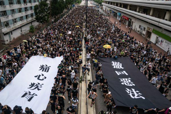 Protesters hold banners as they take part in a pro-democracy march in the Sha Tin district of Hong Kong on July 14, 2019. (Anthony Kwan/Getty Images)