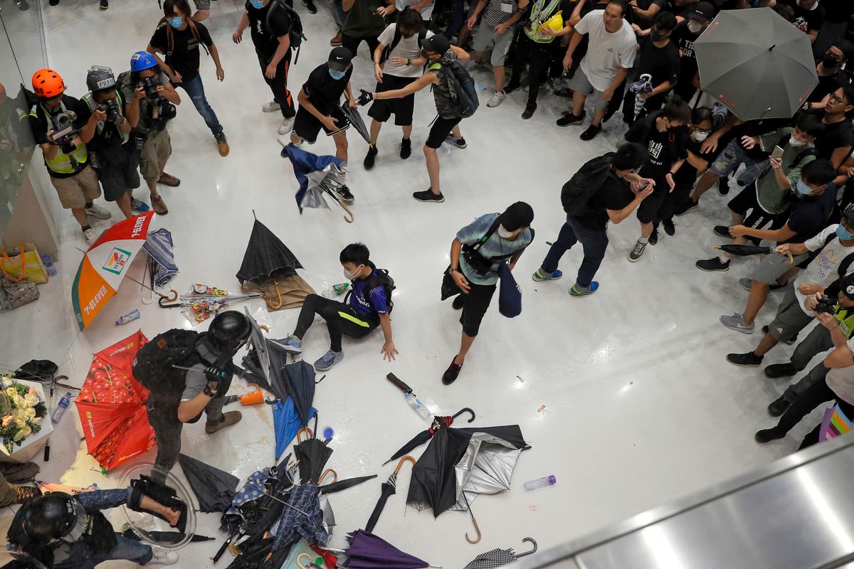 Protesters and policemen clash inside a shopping mall in Sha Tin District in Hong Kong. (AP Photo/Kin Cheung)