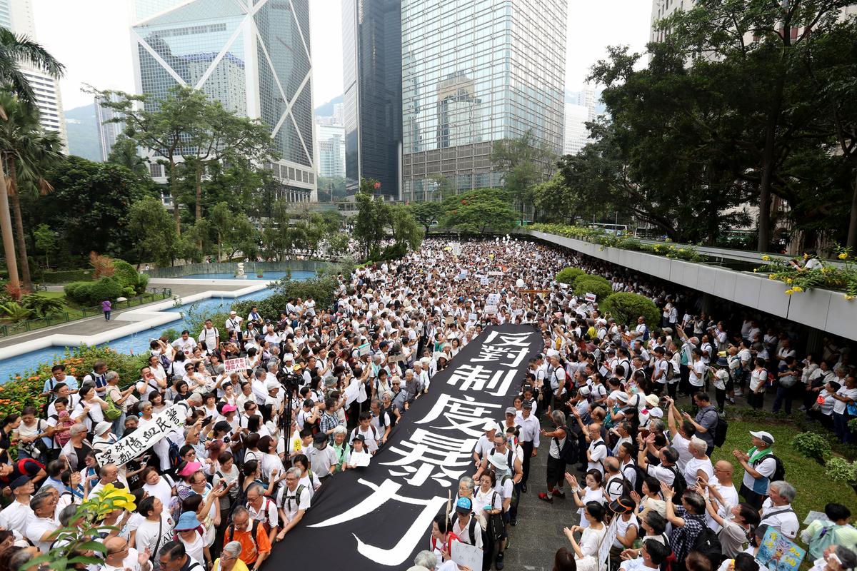 Elderly Hong Kong residents with a banner that reads "Against institutional violence" during a march in Hong Kong on July 17, 2019. (AP)