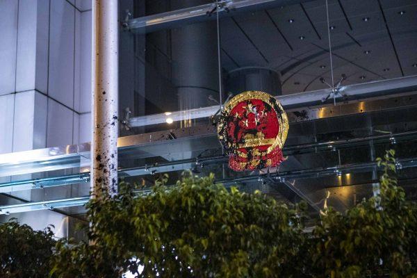 The nation emblem at China’s Liaison Office in Hong Kong is seen smeared with black paint following a largely peaceful march against a controversial extradition bill on July 21, 2019. (Yu Kong/The Epoch Times)