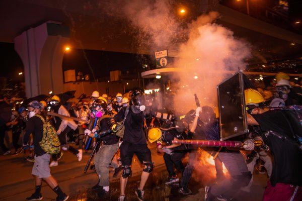 Protesters run away from the tear gas after an anti-extradition bill march in Hong Kong in Hong Kong on July 21, 2019. (Billy H.C. Kwok/Getty Images)