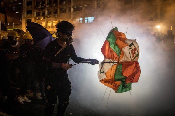 Protesters clash with police amid tear gas after taking part in an anti-extradition bill march in Hong Kong on July 21, 2019. (Chris McGrath/Getty Images)