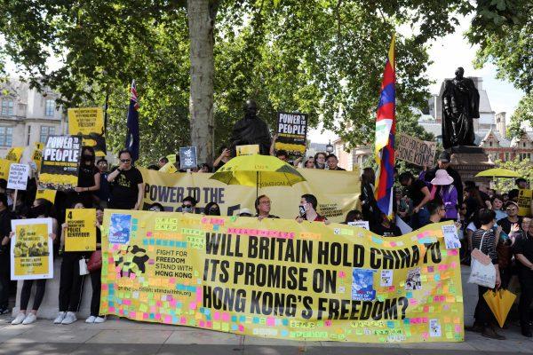 Protesters hold up placards as they gather in central London to attend a march organized by StandwithHK and D4HK in support of pro-democracy protests in Hong Kong, on Aug. 17, 2019. (Isabel Infantes/AFP/Getty Images)