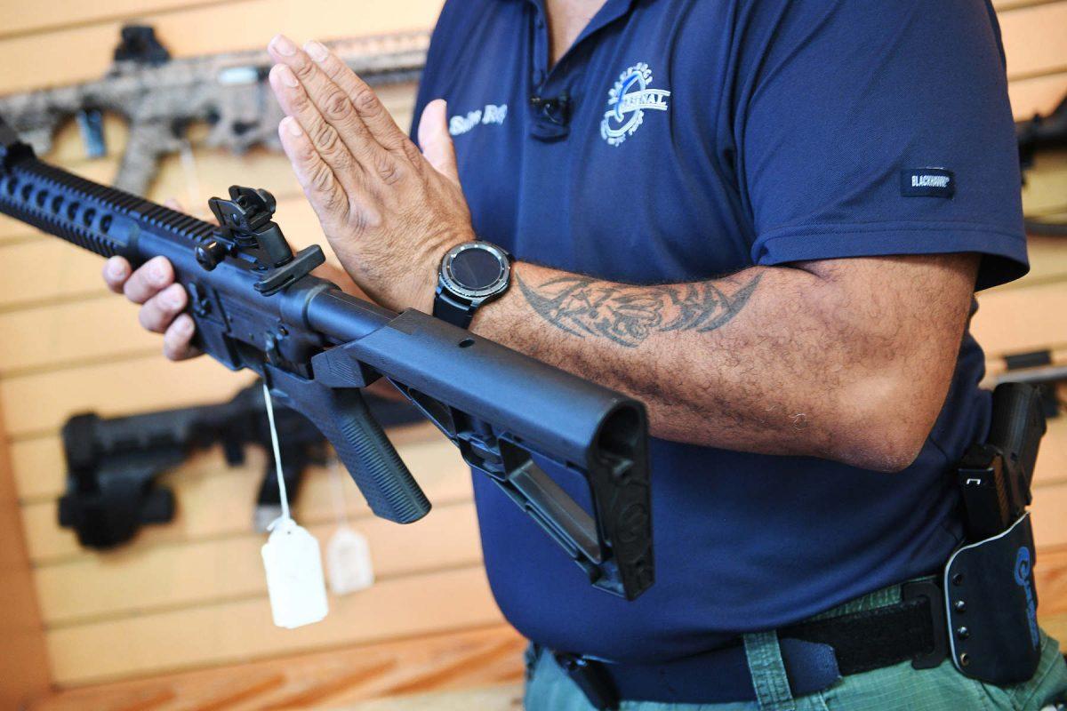 A man shows a bump stock installed on an AR-15 rifle at Blue Ridge Arsenal in Chantilly, Virginia, on Oct. 6, 2017. (Jim Watson/AFP/Getty Images)