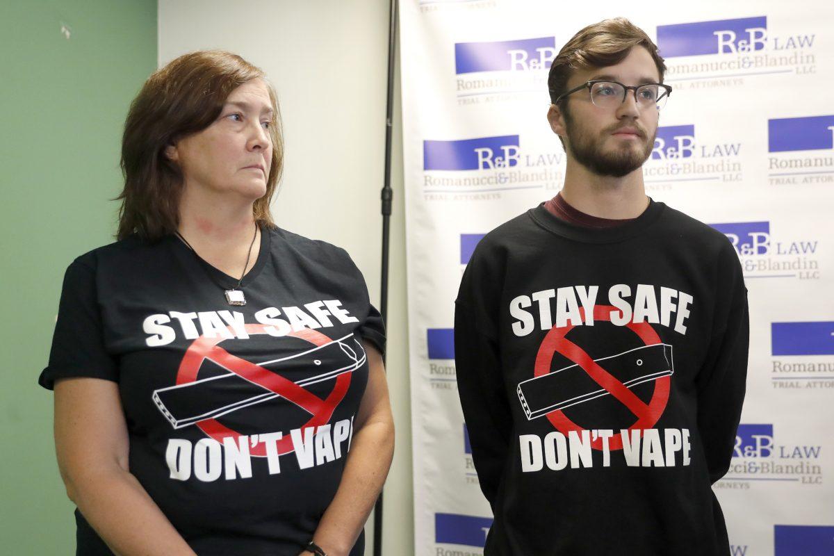 Adam Hergenreder (R) and his mother Polly attend a news conference where their attorney announced the filing of a civil lawsuit against e-cigarette maker Juul in Chicago on Sept. 13, 2019. (Charles Rex Arbogast/AP Photo)
