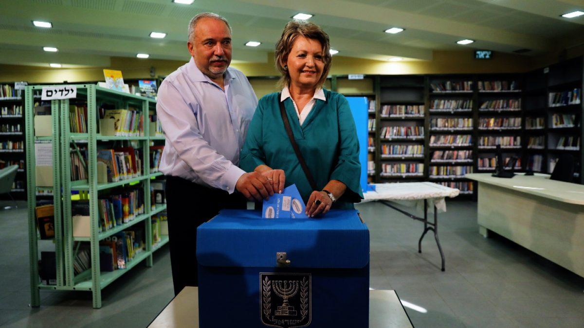 Avigdor Lieberman, leader of Yisrael Beitenu party, casts his ballot in Israel's parliamentary election, along with his wife Ella at a polling station in the Israeli settlement of Nokdim in the occupied West Bank on Sept. 17, 2019. (Ammar Awad/File Photo via Reuters)