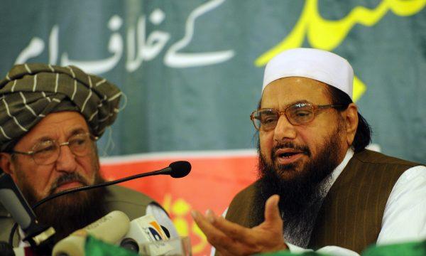 Hafiz Saeed (R), the founder of Lashkar-e-Taiba, talks to media representatives as Maulana Samiul Haq (L), chief of the Defense Council of Pakistan and dubbed father of the Taliban, looks on in Rawalpindi, Pakistan, on April 4, 2012. (Aamir Qureshi/AFP/Getty Images)
