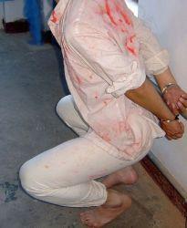 Reenactment of squatting torture. (Minghui.org)