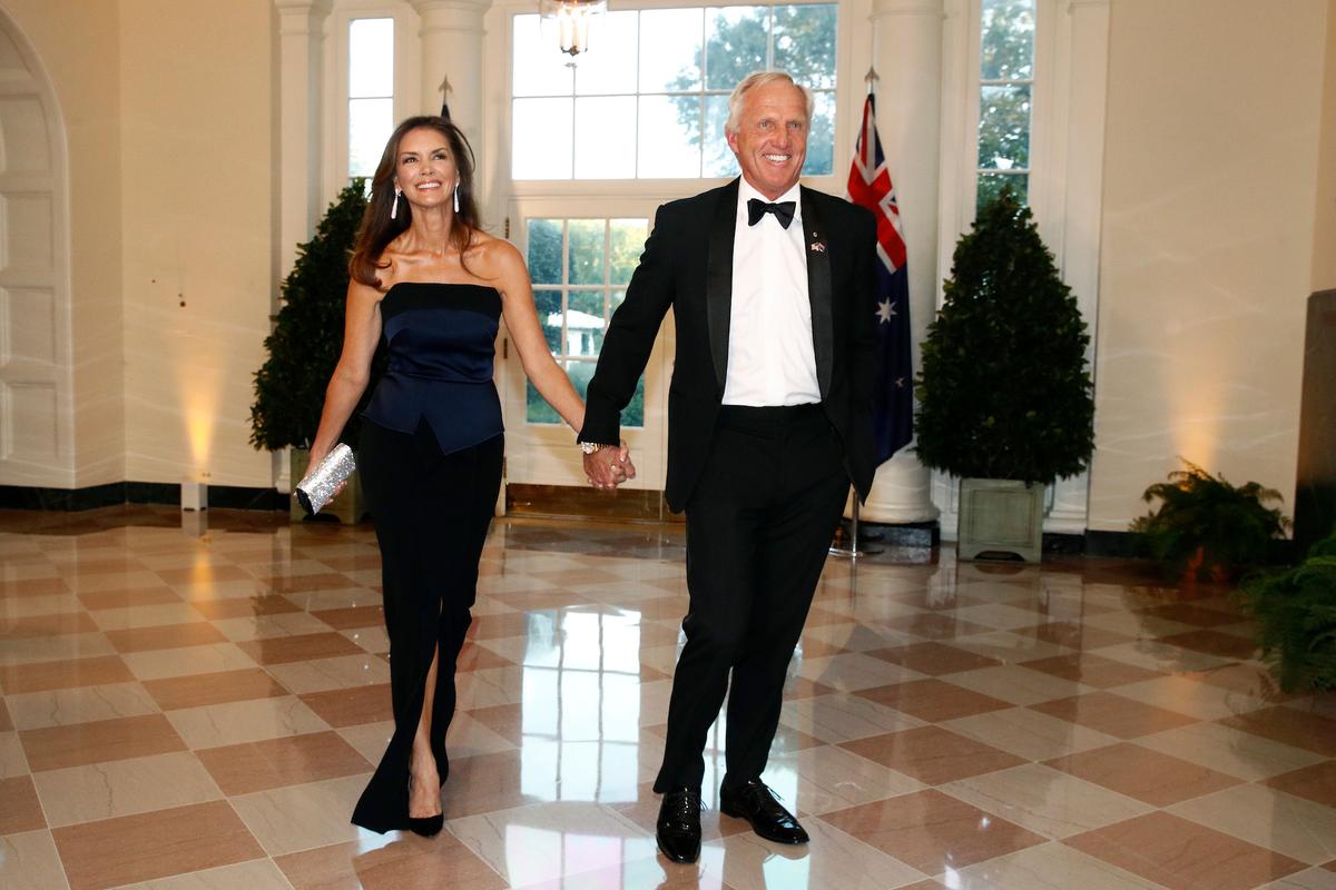 Golfer Greg Norman, right, and wife Kirsten Kutner arrive for a State Dinner with Australian Prime Minister Scott Morrison and President Donald Trump at the White House, in Washington on Sept. 20, 2019. (AP Photo/Patrick Semansky)
