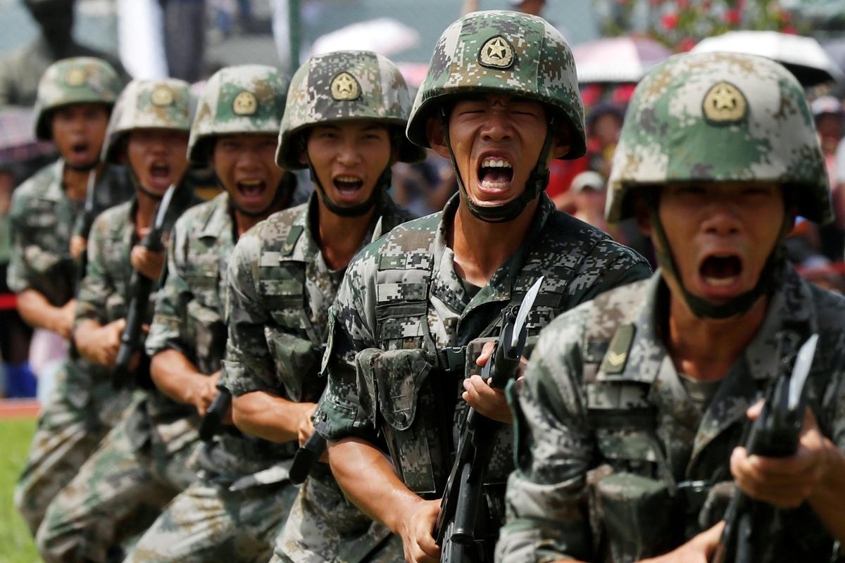 People's Liberation Army (PLA) soldiers take part in a performance during an open day at Stonecutters Island naval base in Hong Kong, China on June 30, 2019. (Tyrone Siu/Reuters)
