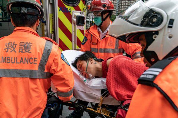 A pedestrian is lifted into an ambulance after inhaling tear gas in Wan Chai district in Hong Kong on Oct. 6, 2019. (Anthony Kwan/Getty Images)