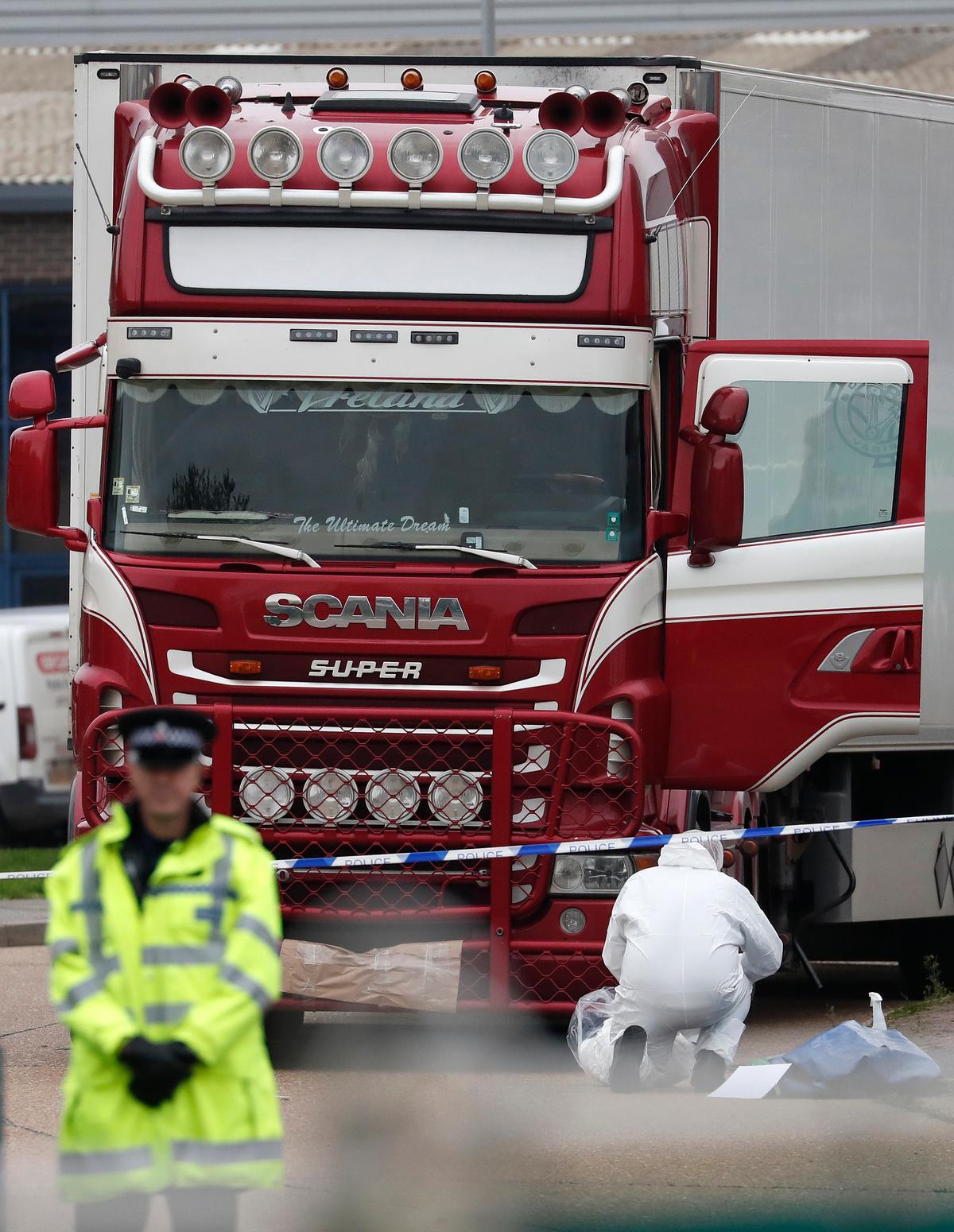 Police forensic officers attend the scene after a truck was found to contain a large number of dead bodies, in Thurrock, South England, on Oct. 23, 2019. (Alastair Grant/AP)