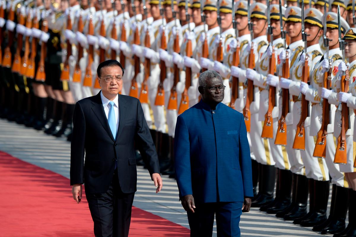 Solomon Islands Prime Minister Manasseh Sogavare (R) and Chinese Premier Li Keqiang inspect honor guards during a welcome ceremony at the Great Hall of the People in Beijing on Oct. 9, 2019. (Wang Zhao/AFP via Getty Images)