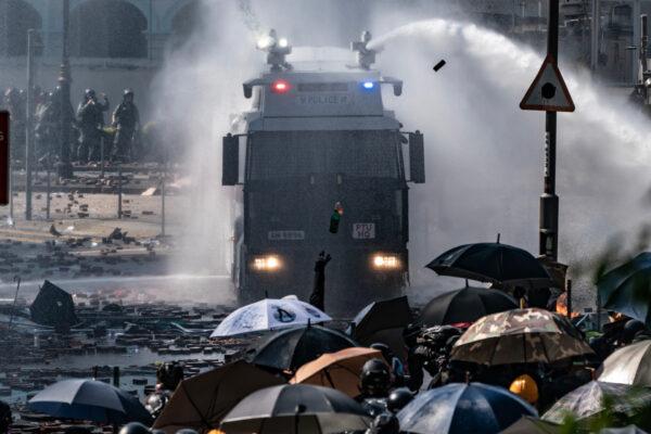Police fire water canon from a vehicle as a protesters throw a fire bomb at the Hong Kong Poytechnic University on Nov. 17, 2019 in Hong Kong. (Anthony Kwan/Getty Images)