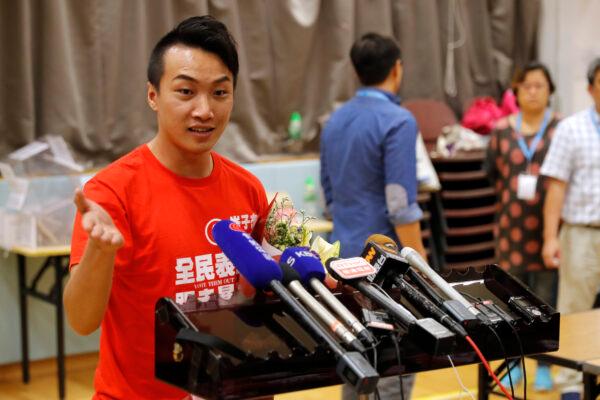 Pro-democracy candidate Jimmy Sham (L) speaks to reporters after winning his election in Hong Kong, on Nov. 25, 2019. (AP Photo/Vincent Thian)