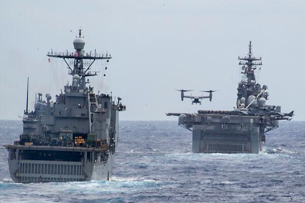 An MV-22 Osprey lands on the amphibious assault ship USS Boxer (LHD 4) while the amphibious dock landing ship USS Harpers Ferry (LSD 49) follows. (U.S. Navy photo by Mass Communication Specialist 2nd Class Kyle Carlstrom)