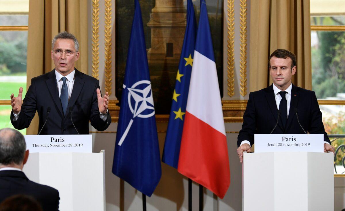 NATO Secretary-General Jens Stoltenberg, left, speaks as French President Emmanuel Macron listens during a news conference in Paris, France on Nov. 28, 2019. (Bertrand Guay/Pool via Reuters)