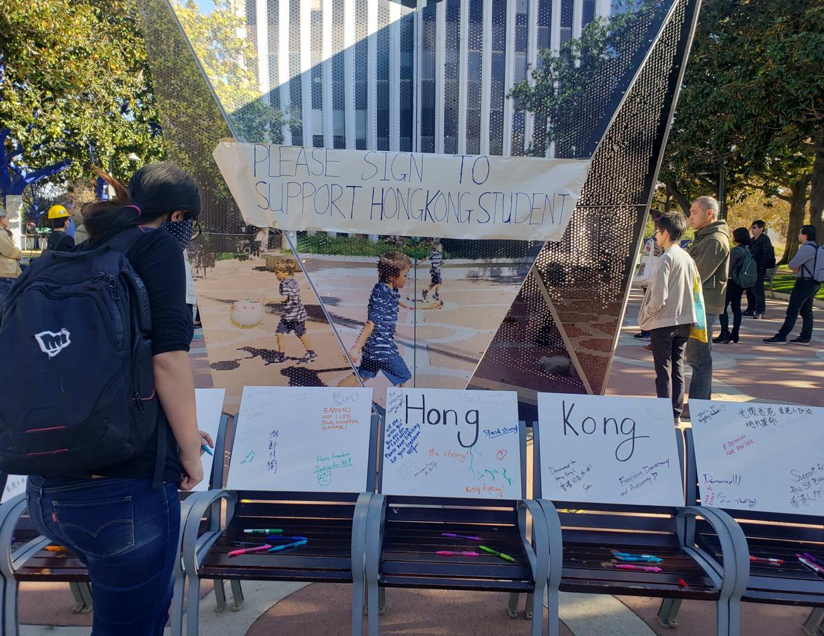 Signs call for signatures in support of Hong Kong students, in front of Palo Alto City Hall on Nov. 24, 2019. (David Lam/The Epoch Times)