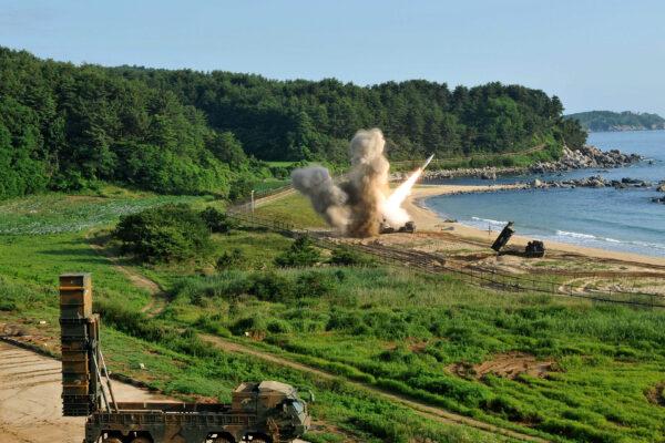 U.S. M270 Multiple Launch Rocket System (R) firing an MGM-140 Army Tactical Missile on South Korea's East Coast on July 5, 2017. (United States Forces Korea via Getty Images)