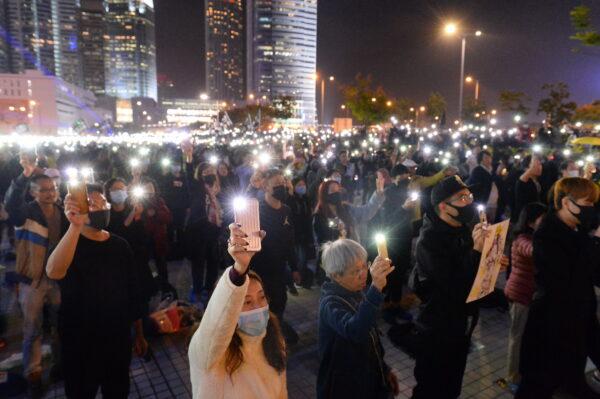Protesters hold up their cellphone lights in a rally at Edinburgh Place in Hong Kong, on Dec. 12, 2019. (Sung Pi-lung/The Epoch Times)