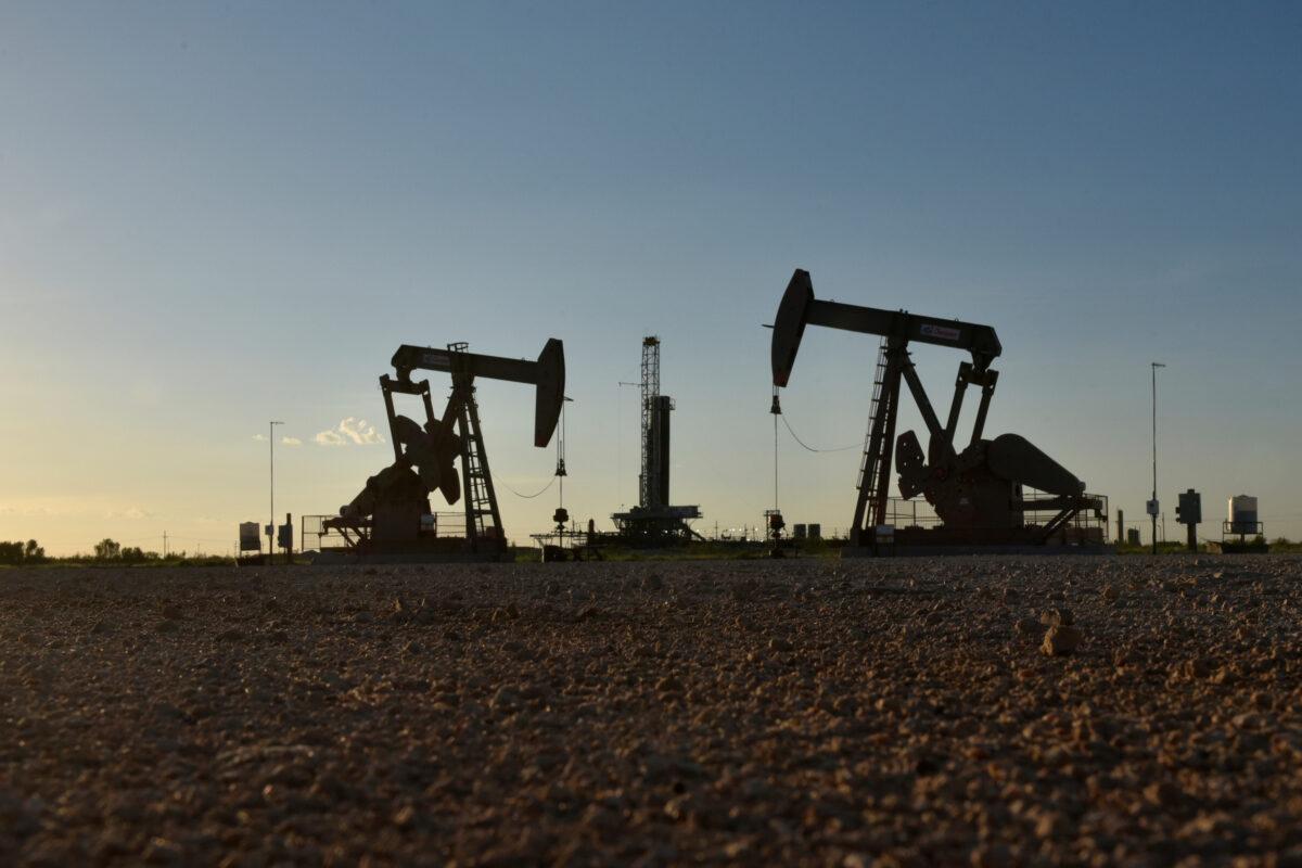Pump jacks operate in front of a drilling rig in an oil field in Midland, Texas, on Aug. 22, 2018. (Reuters/Nick Oxford/File Photo)