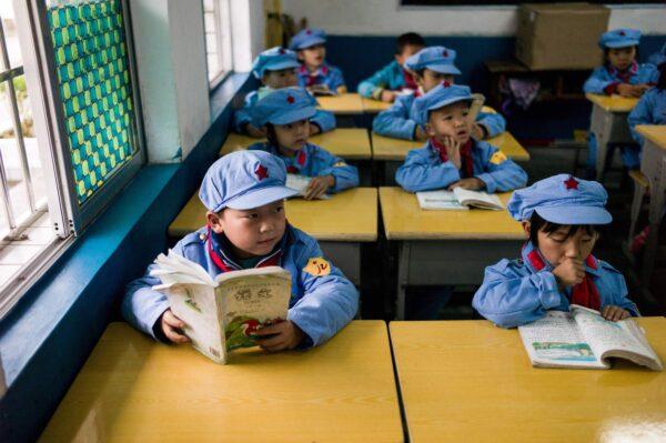 Pupils in their classroom in the Yang Dezhi "Red Army" elementary school in Wenshui, Xishui County in Guizhou Province, China on Nov. 7, 2016. Such schools are an extreme example of the "patriotic education" which China's ruling Communist party promotes to boost its legitimacy—but critics condemn as little more than brainwashing. (Fred Dufour/AFP via Getty Images)