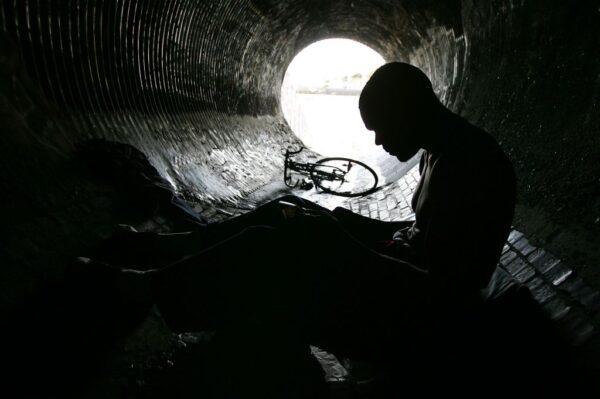 Donald Rayfield smokes crack cocaine in an underground storm drain in Los Angeles, California, on Jan. 18, 2006. (David McNew/Getty Images)