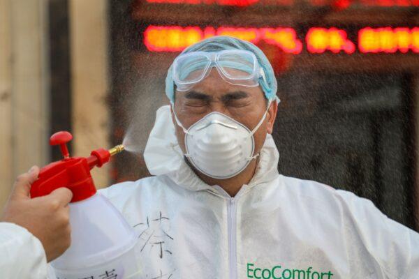A doctor being disinfected by his colleague at a hospital in Wuhan, China on Feb. 3, 2020. (STR/AFP via Getty Images)