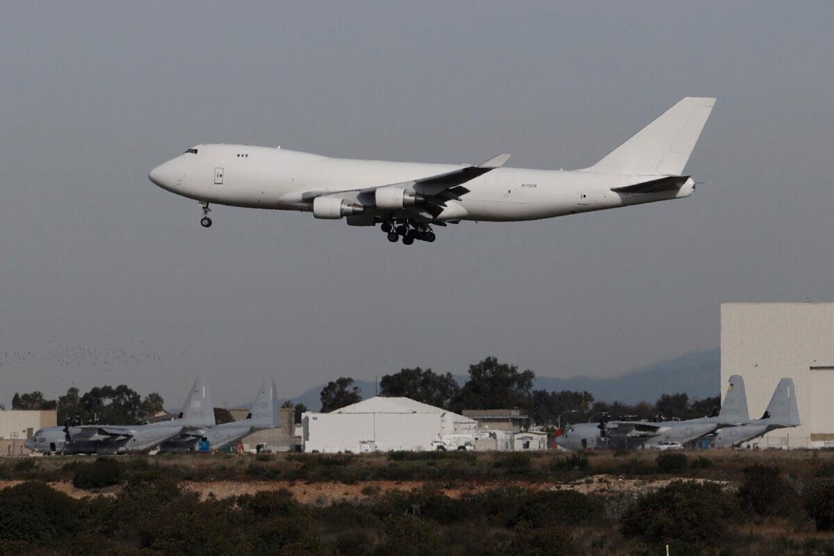 A plane carrying evacuees from the virus zone in China lands at Marine Corps Air Station Miramar, in San Diego, on Feb. 5, 2020. (Gregory Bull/AP)
