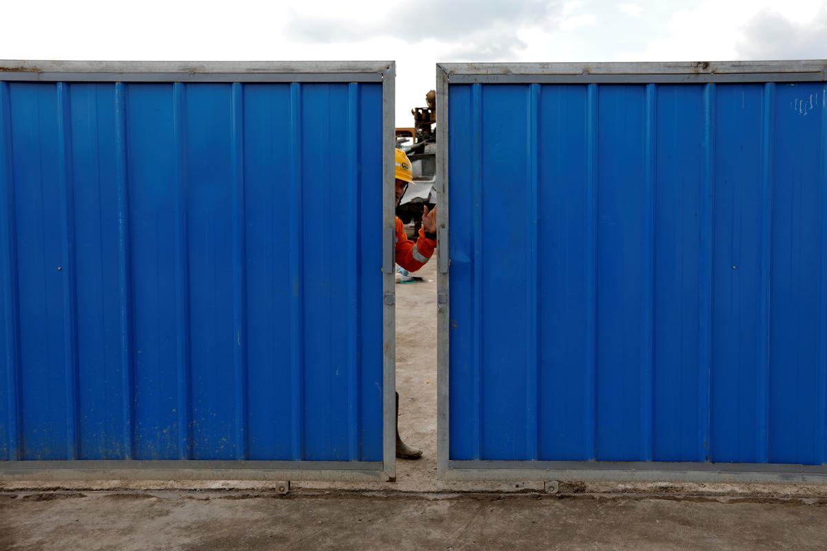 A worker closes the gate at Walini tunnel construction site for Jakarta-Bandung High Speed Railway in West Bandung regency, West Java province, Indonesia, on Feb. 21, 2019. (Willy Kurniawan/Reuters)